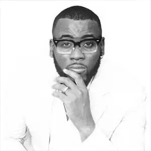 Black-and-white professional portrait of Joseph Franklin Jr wearing glasses and formal attire.